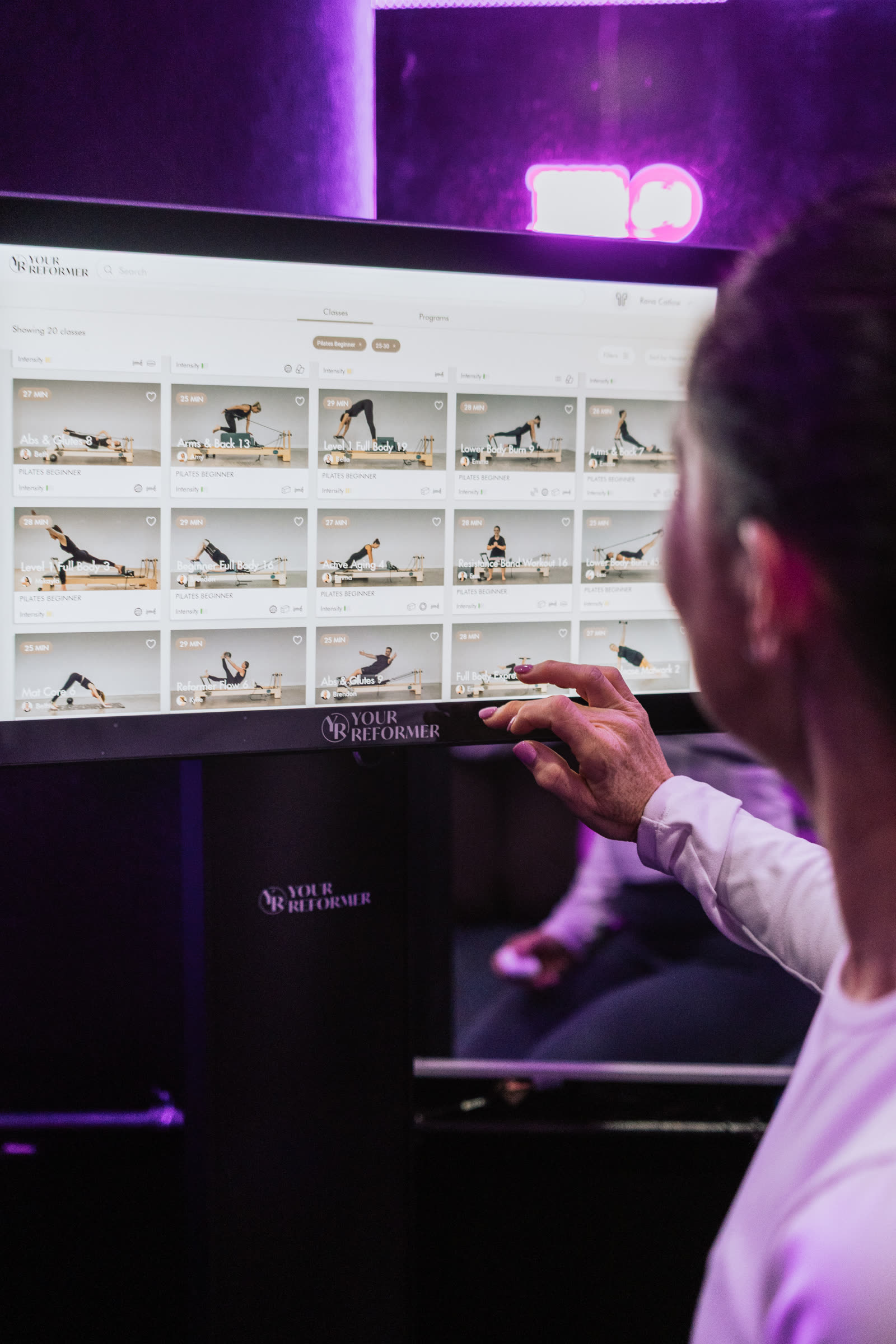 Member following an on-screen reformer class